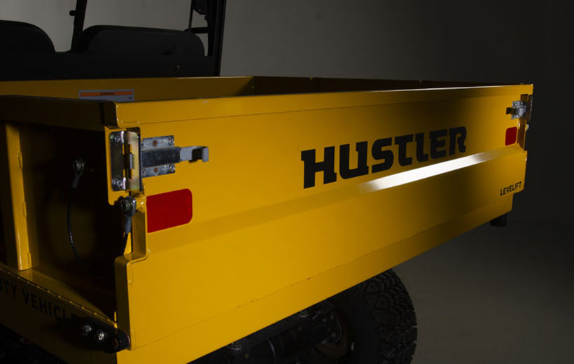Image of the tail gate of a utility vehicle with 2 red reflectors on either end of the gate.