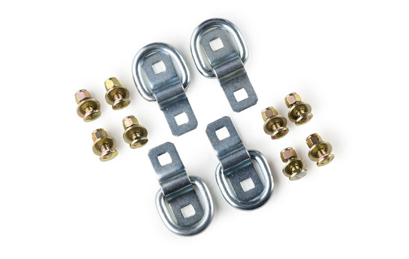 Image of the bolts and tie down pieces on a white background.