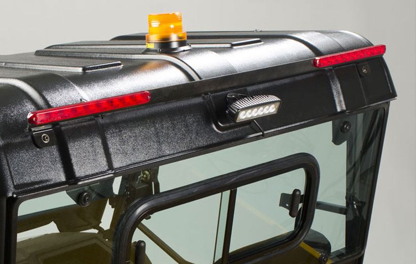 Image of the back roof line of a utility vehicle with red brakes lights and a center tail light mounted to it.