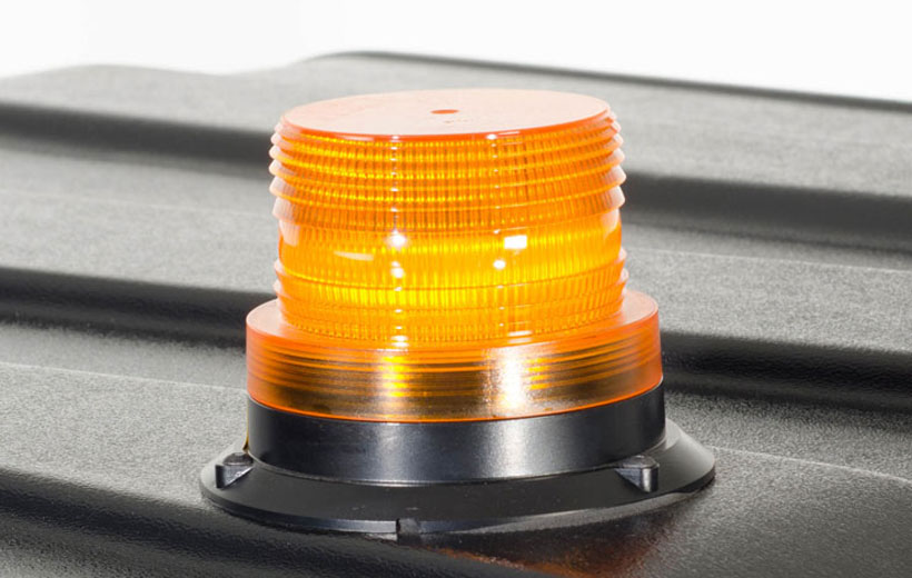 Image of an orange cylindrical light mounted on a utility vehicle roof.