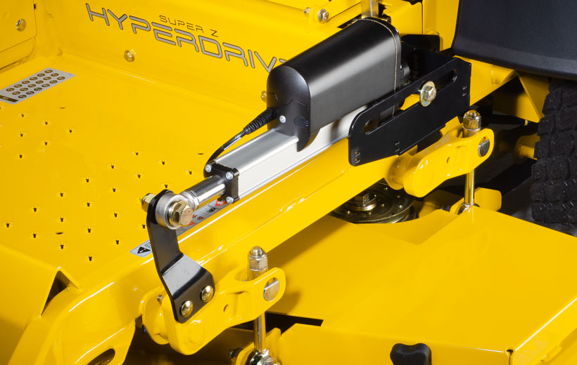 Image of an black electric accuator mounted on a bar above a mower deck