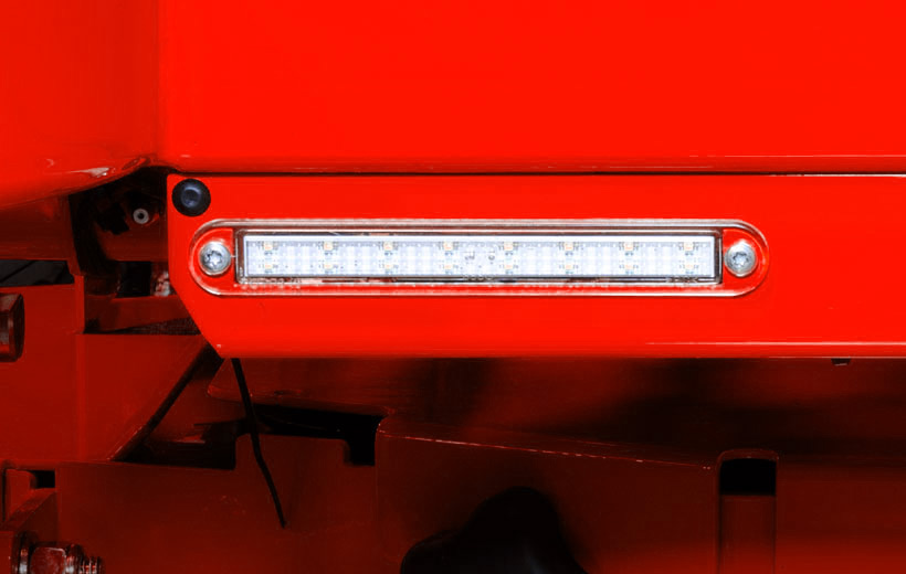 Image of the front of a red mower with a light bar mounted to the frame
