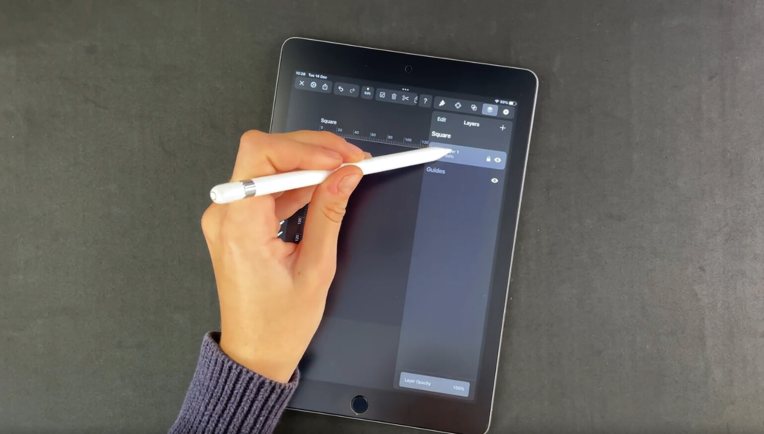 Hand with stylus interacting with a layers panel on a digital tablet with design software