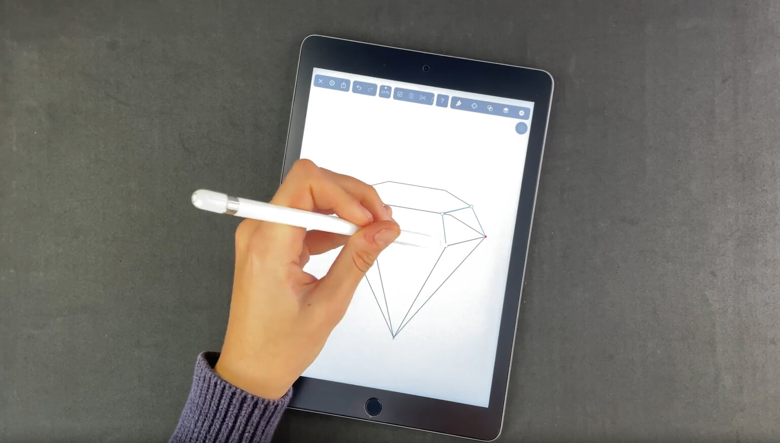 Hand drawing a diamond with a stylus on a tablet