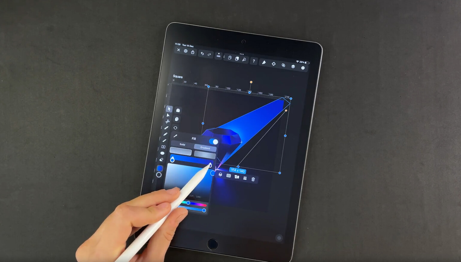 Stylus adjusting a blue gradient shape on tablet screen