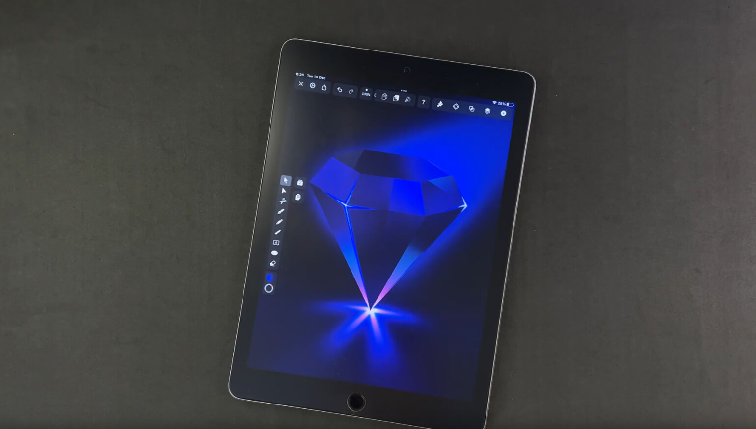 Digital tablet displaying a glowing blue diamond graphic