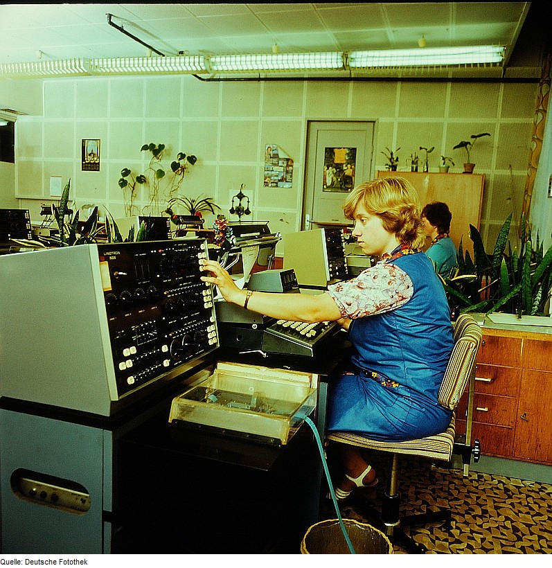 Woman operating vintage communication equipment.