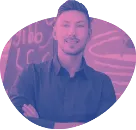 A cutout of web design and branding professional Aidan Quigley in pink and purple, smiling with arms folded