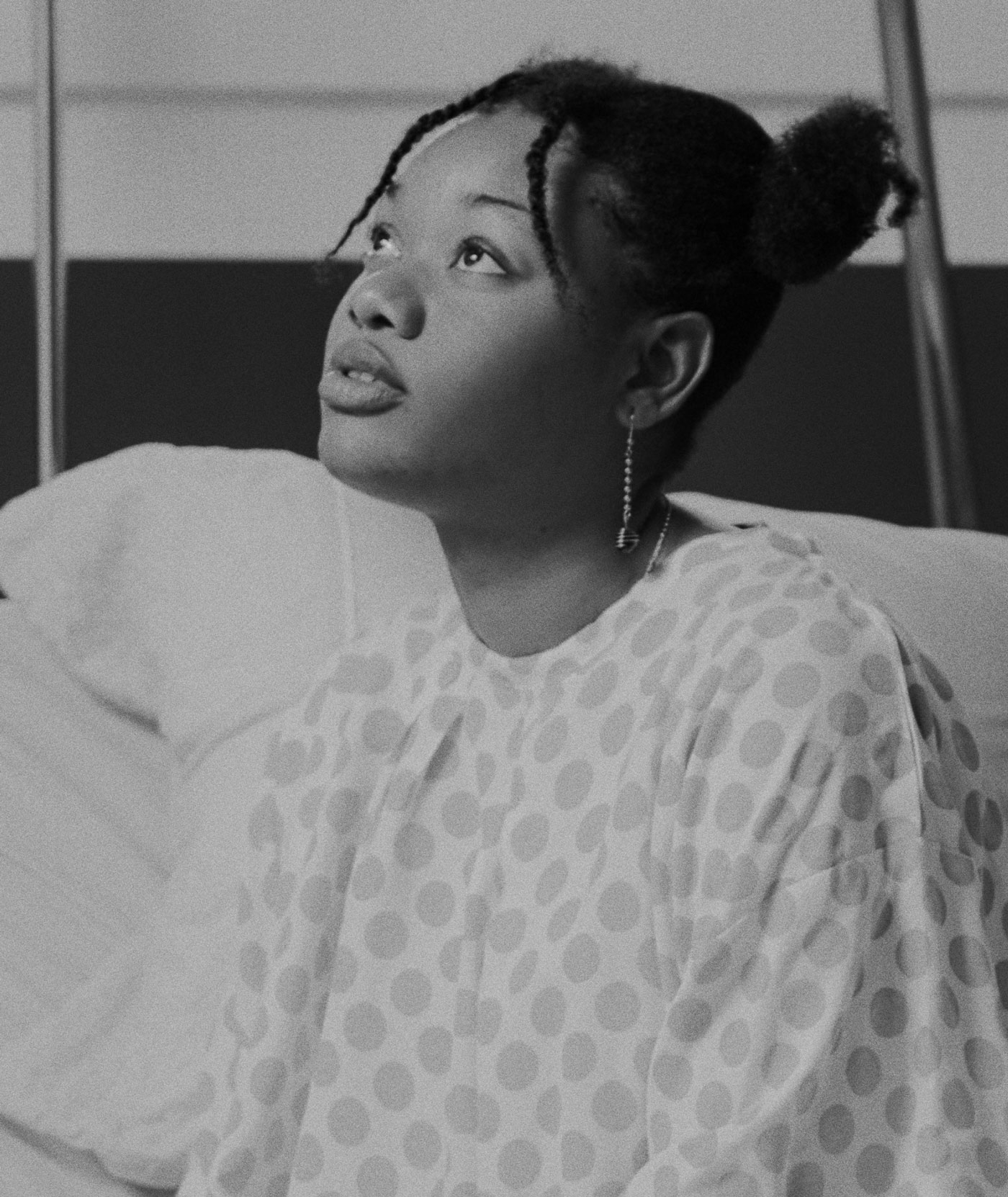 Black patient in hospital gown.