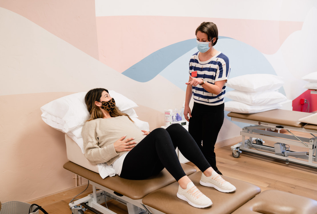An Origin physical therapist providing in-person care at one of our spa-like clinics