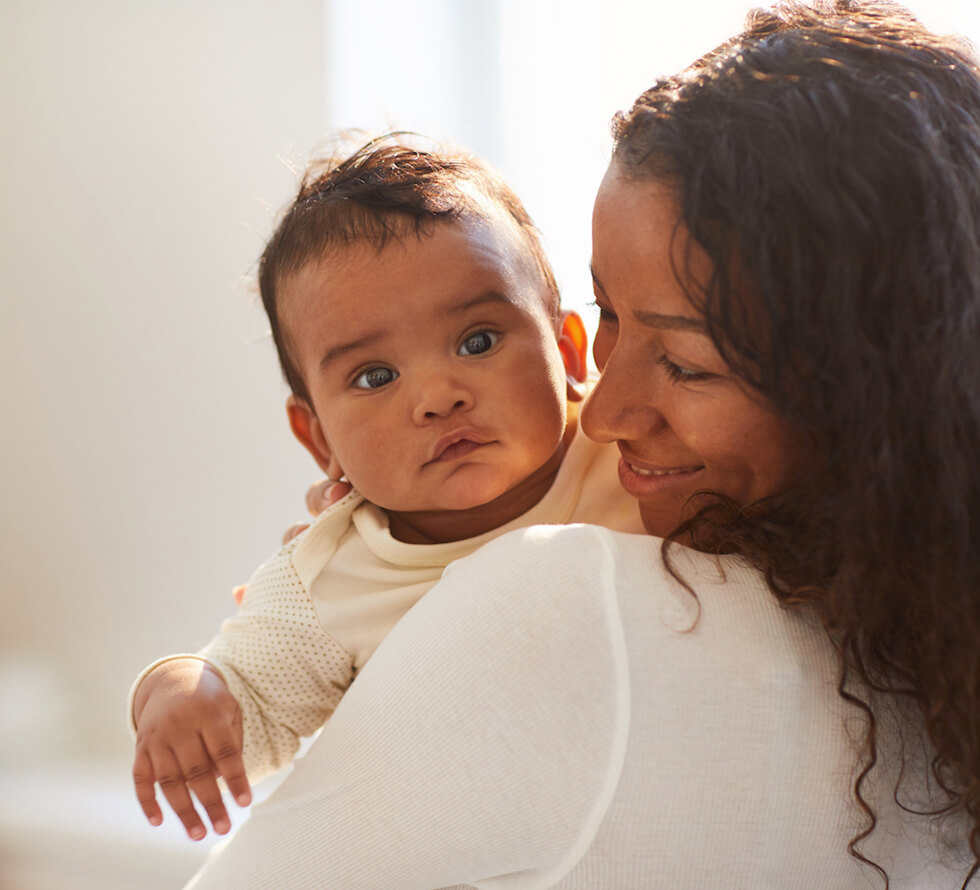 Mother with infant looking over her shoulder
