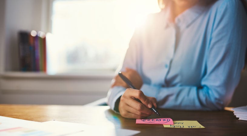 Woman Preparing Paperwork For Moving Overseas Checklist