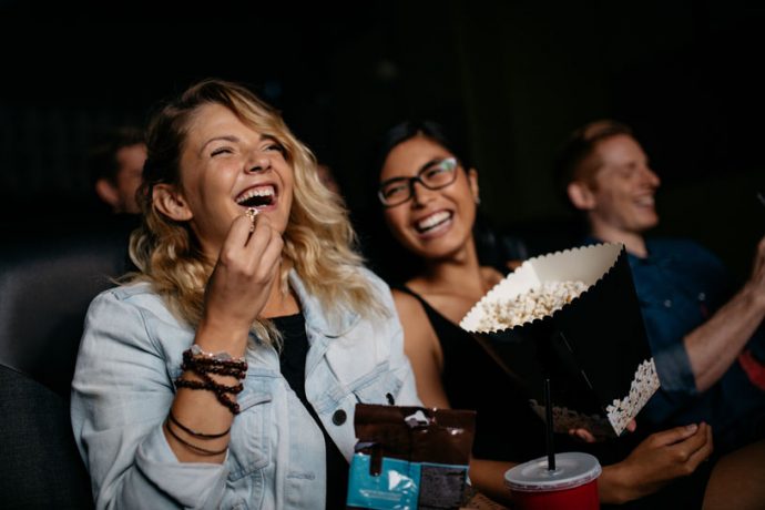 women enjoying cinema entertainment