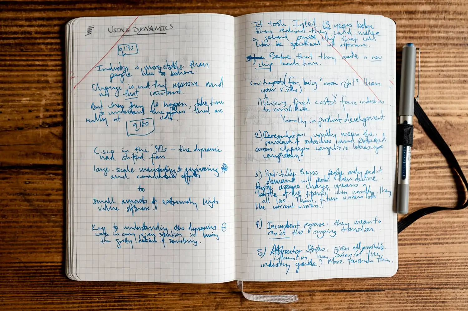 A photo of a notebook, lying open, with handwritten notes covering both pages.