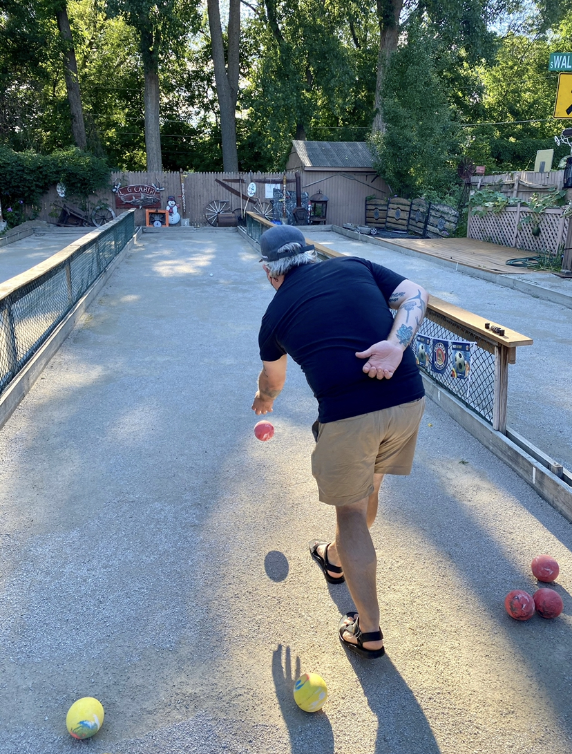 man throwing bocce ball