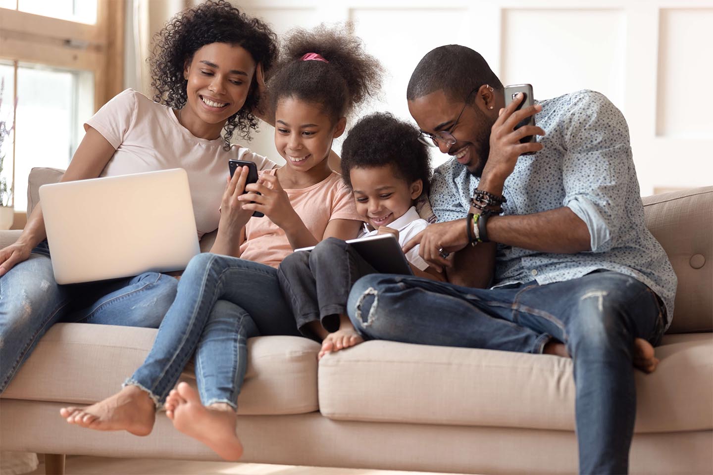 Family of 4 enjoying technology