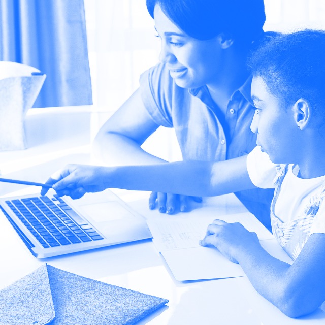 Mother and daughter learning at computer.