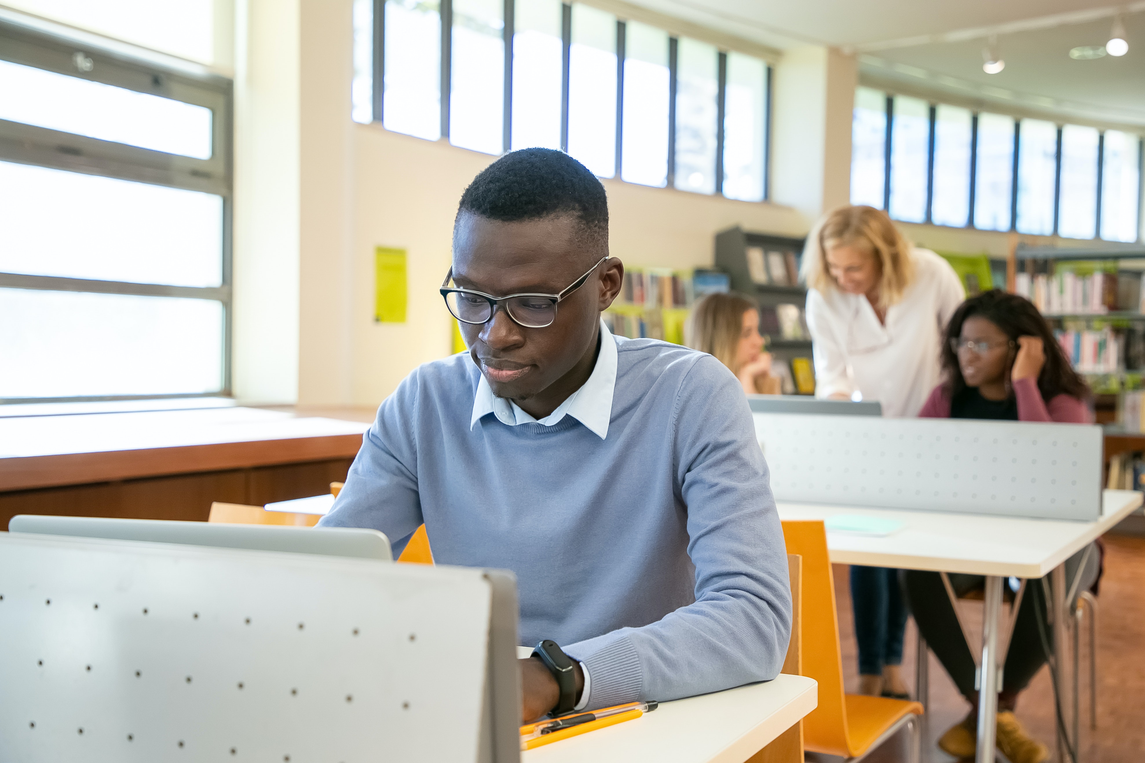 Student coding in library