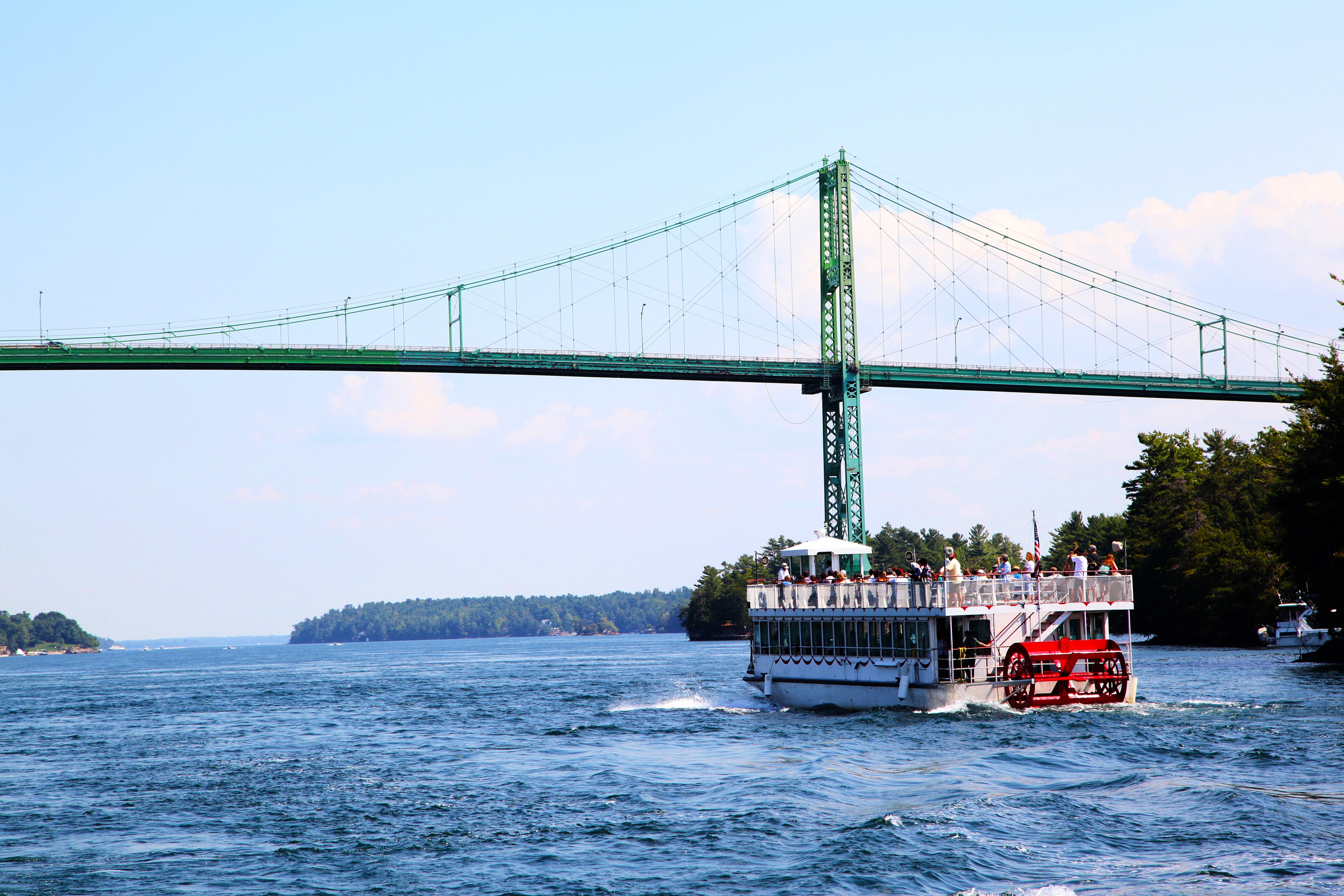 Tour boat passing under a scenic bridge