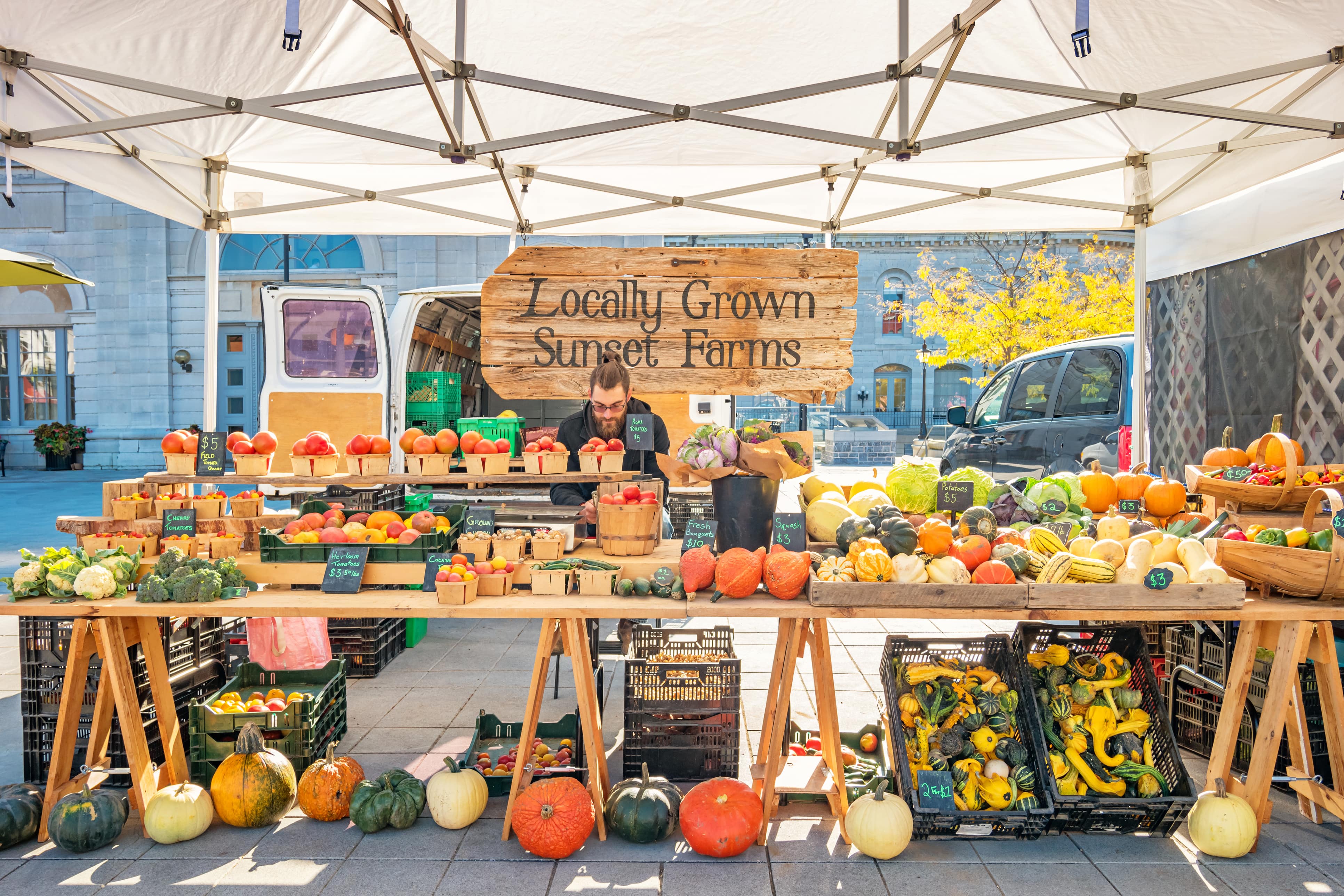 Clerk at a local produce stand in a market