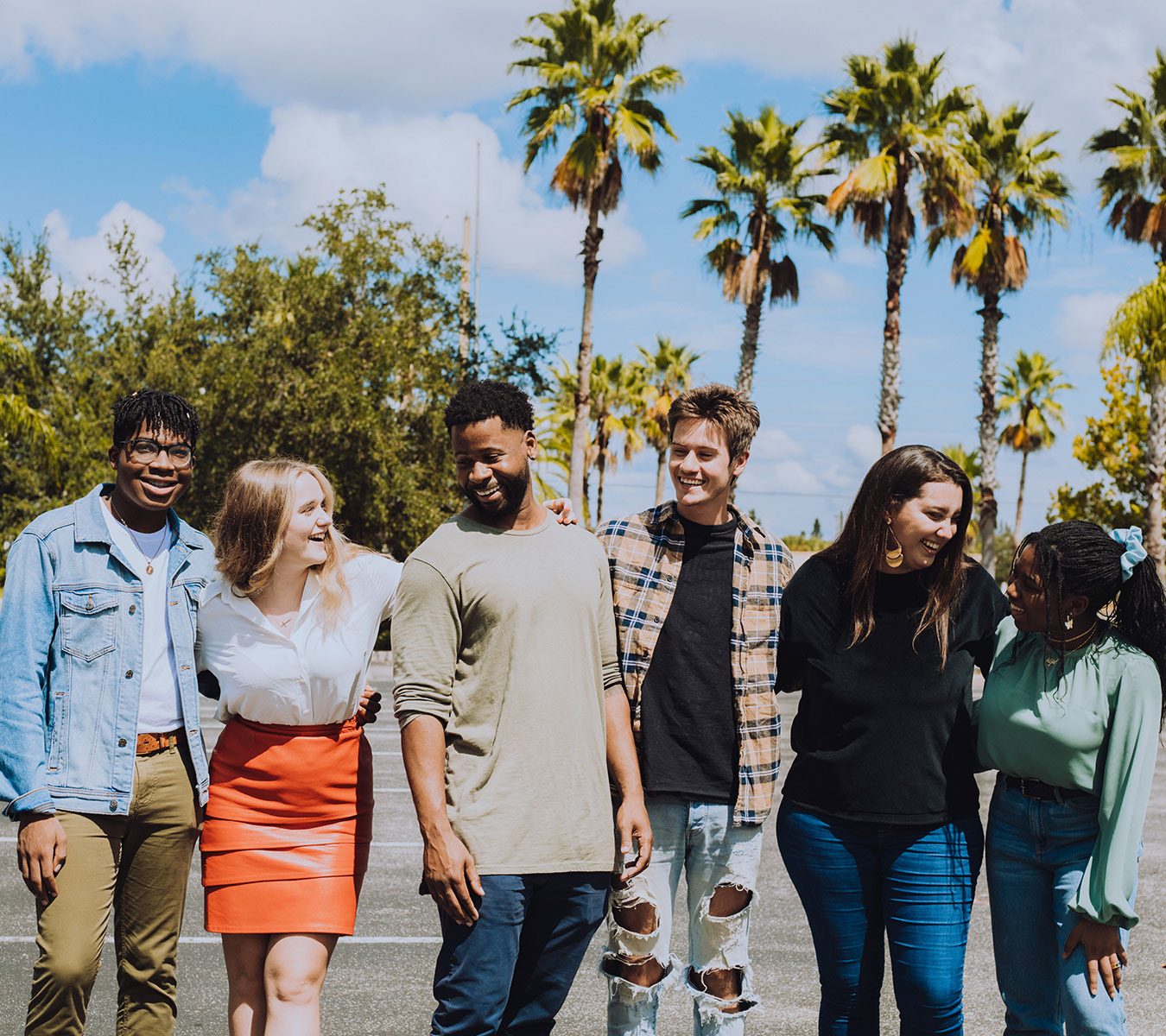 A group of people laughing and looking at each other.
