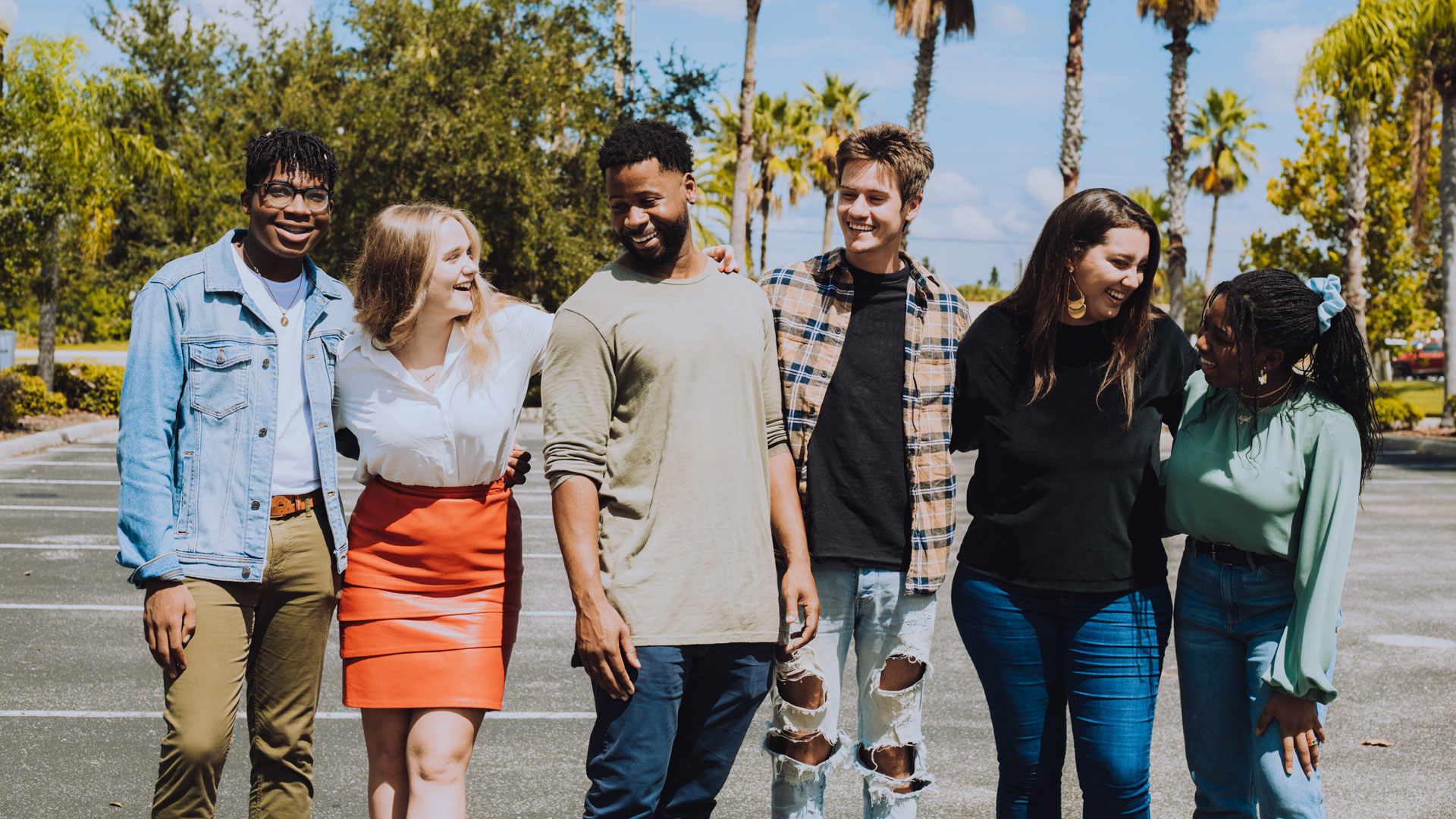 A group of people laughing and looking at each other.