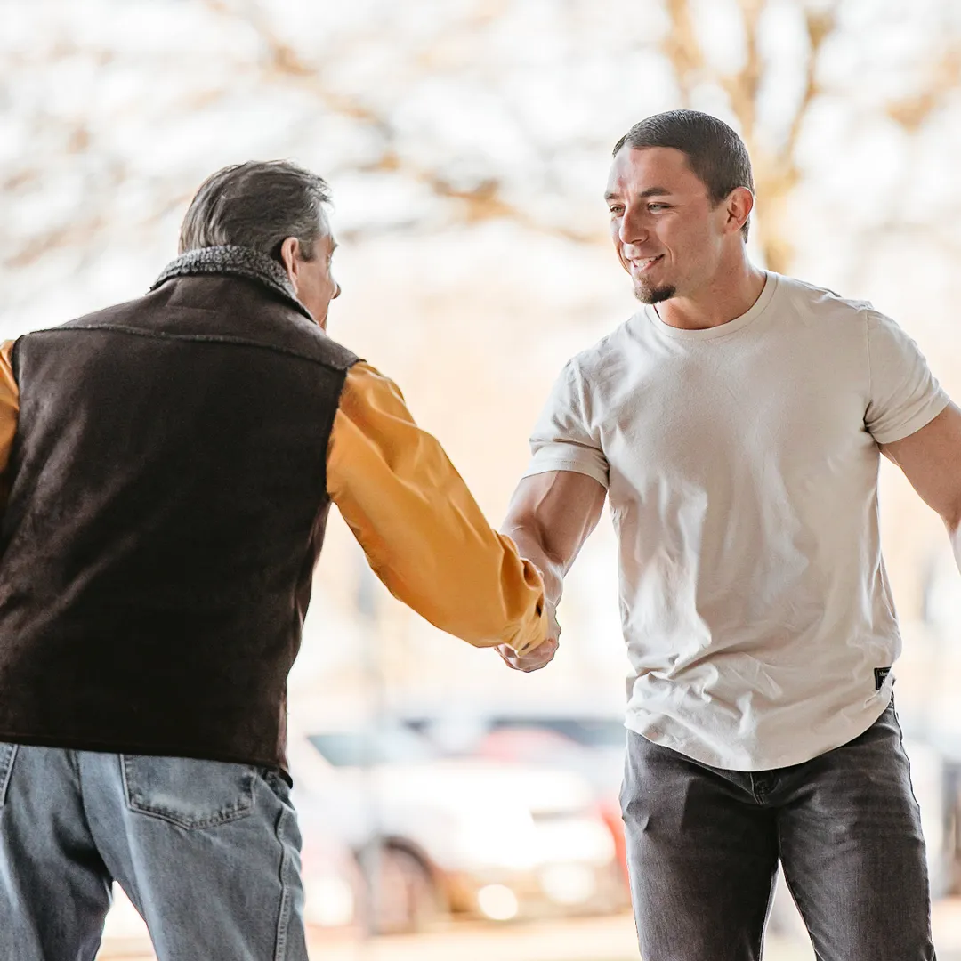 Reach Out - Two men shaking hands