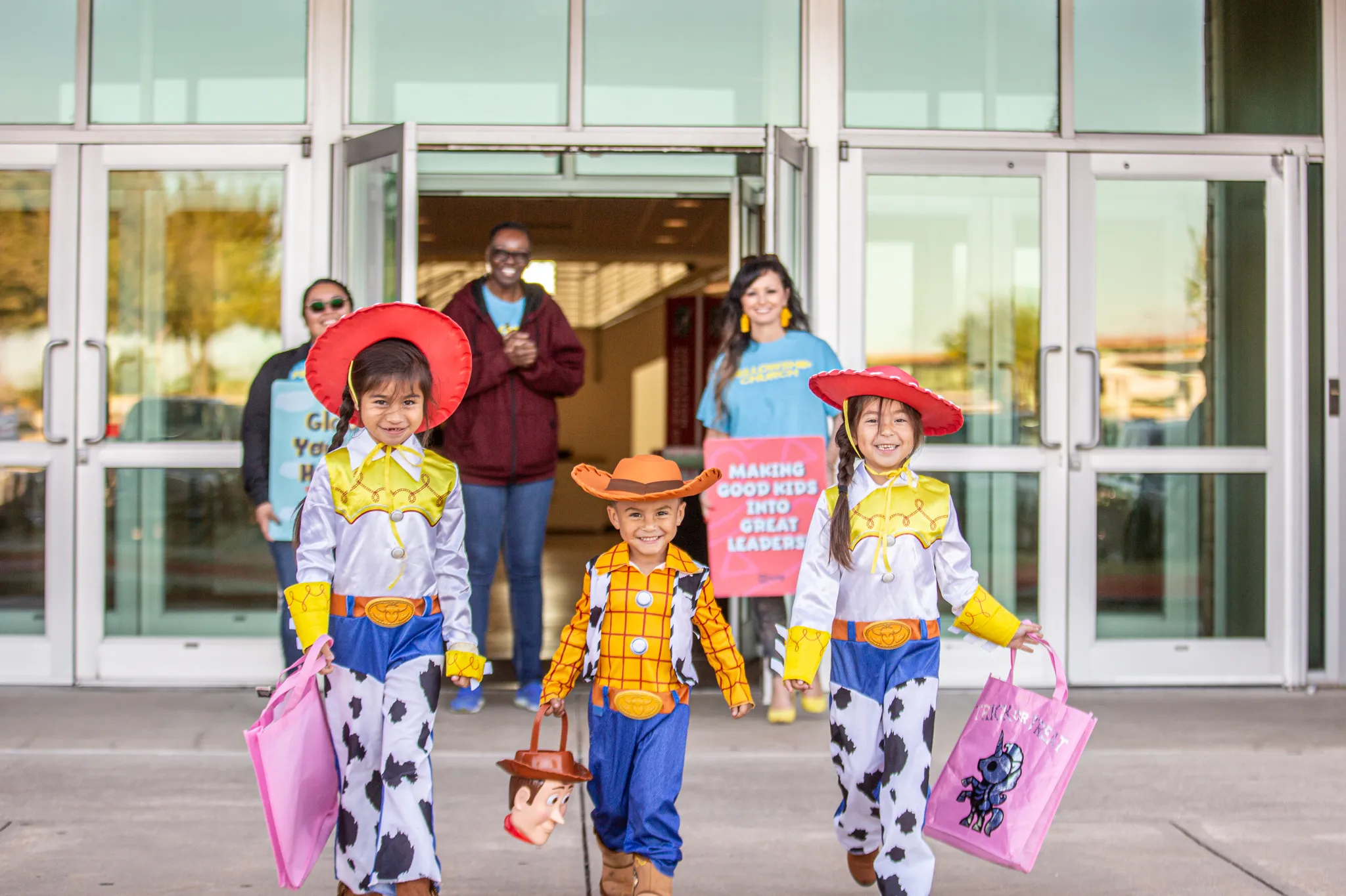 Three children dressed up as cowboys and cowgirls