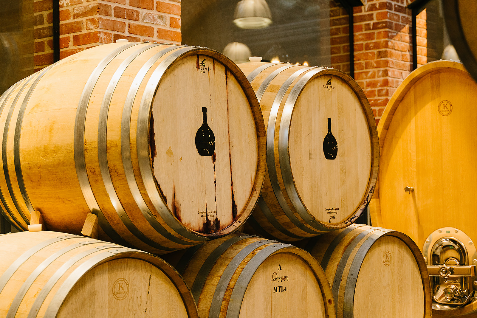 Large wine barrels stacked on top of each other with the Carboy Winery logo printed on them. 