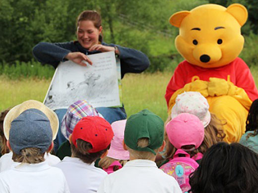 Winnie the Pooh at storytelling in Aldenham Country Park with children