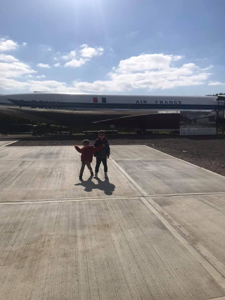 Two young boys in front of an aircraft at the De Havilland museum