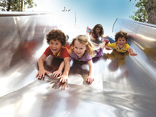 kids racing down the slide at the Olympic Park