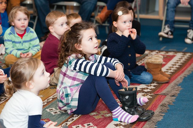 Boys and girls attentively listening to a story