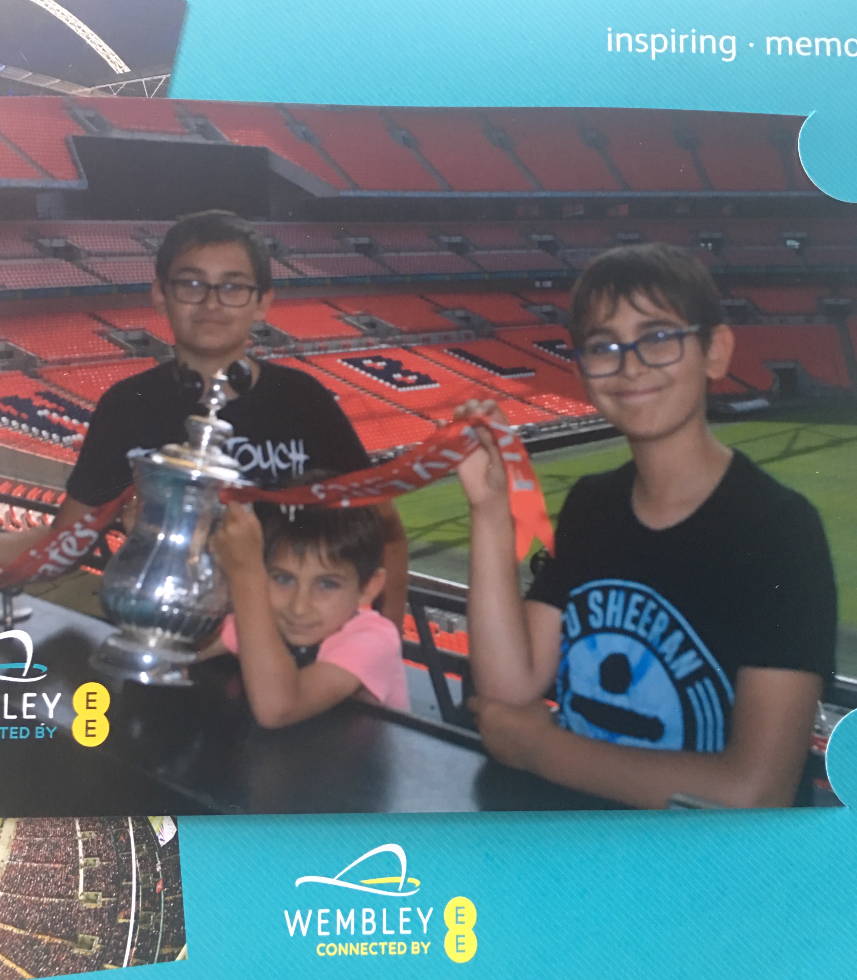 three brothers posing with the FA cup