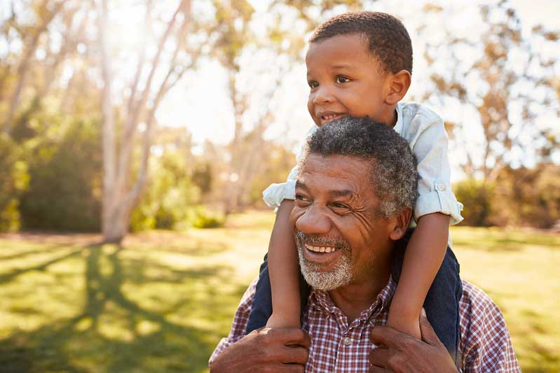 Grandfather with grandson on his shoulders