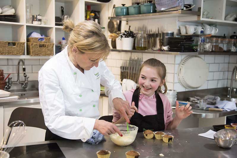 adult and child baking together