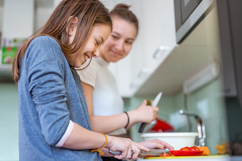mother and daughter cooking
