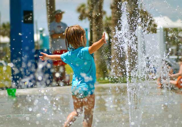 girl playing in splash pad