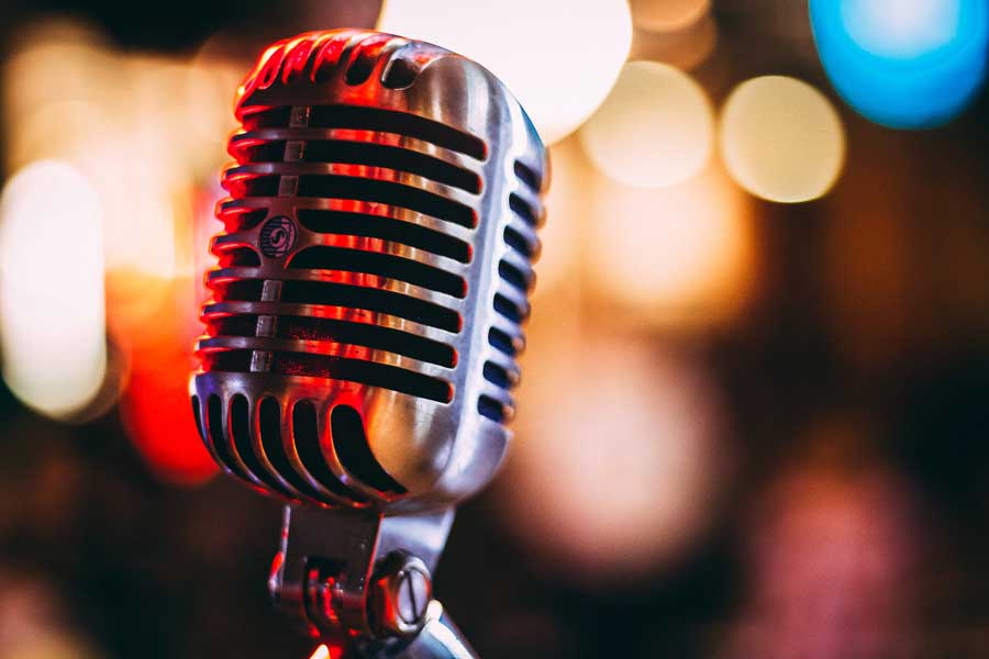 close-up shot of microphone with colourful soft-focus background