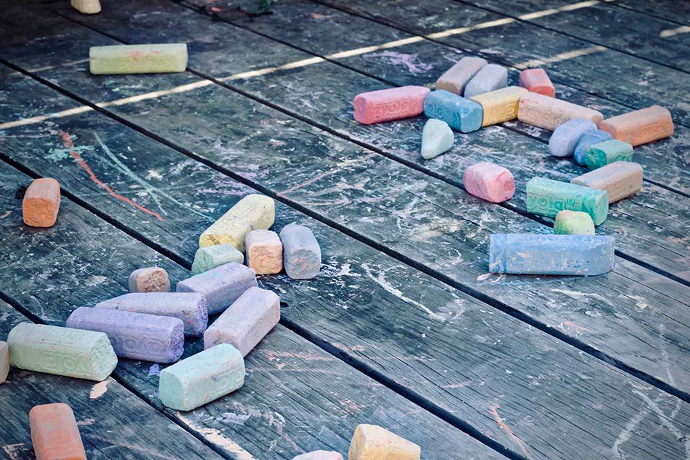 coloured chalks laid out on hard wood floor