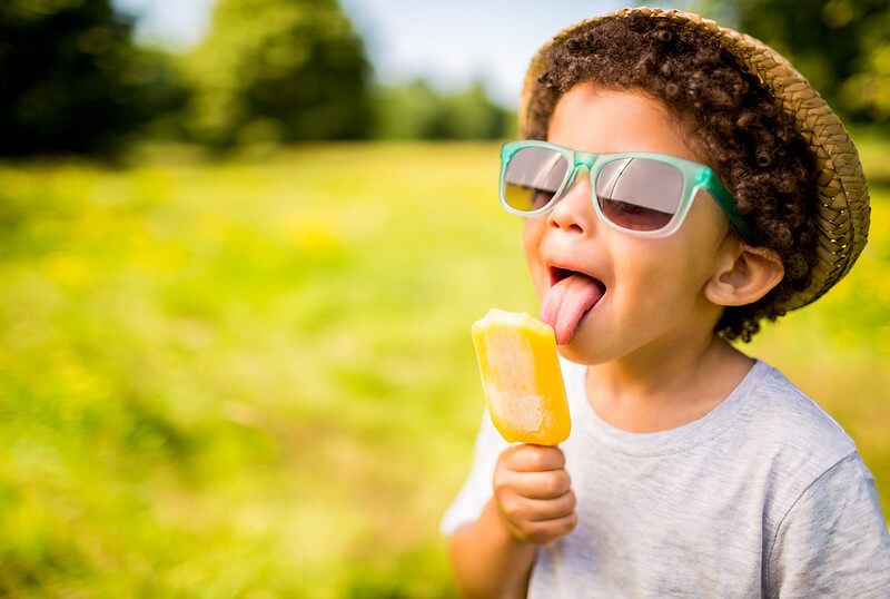 Boy having lollipop celebrating Glastonbury at home