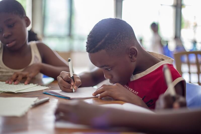 Child revising for SATs with his friends