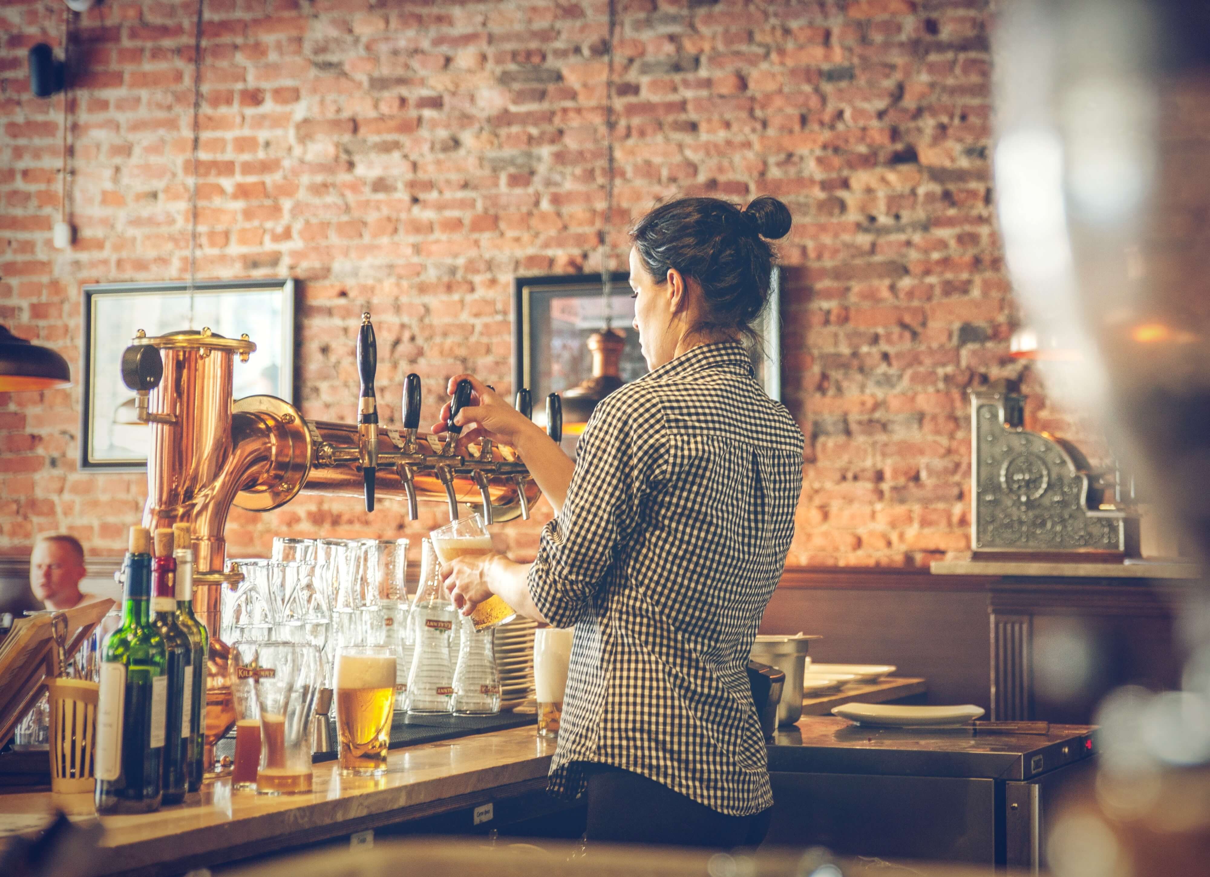 Woman Pouting Pint In A London Pub