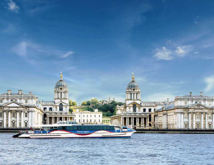 Thames Clipper boat on the river against blue sky.