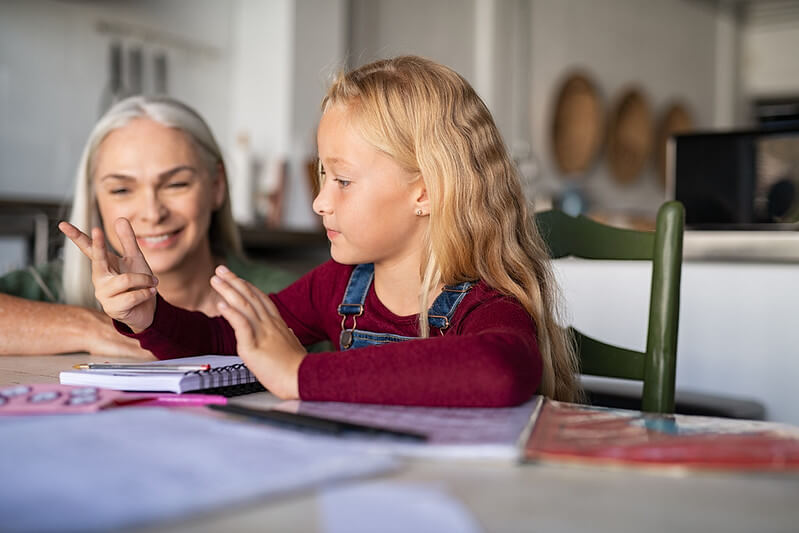Child practicing maths for SATs with parent