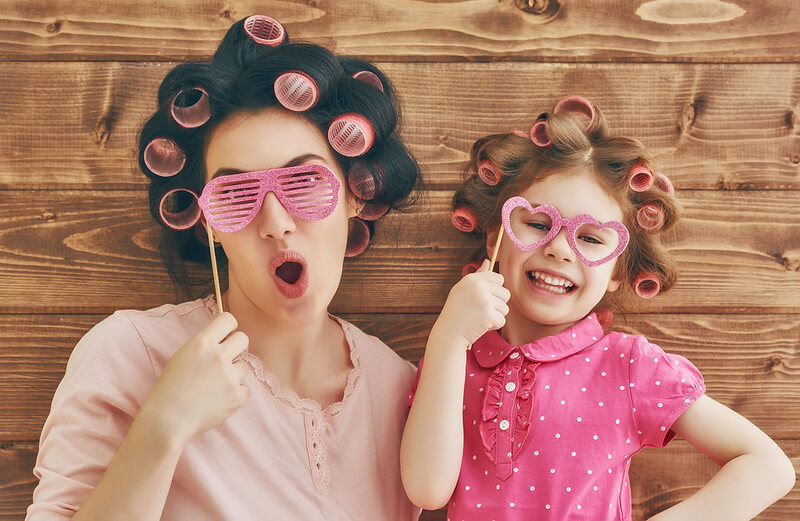 Mother and daughter waiting to cut child's hair at home