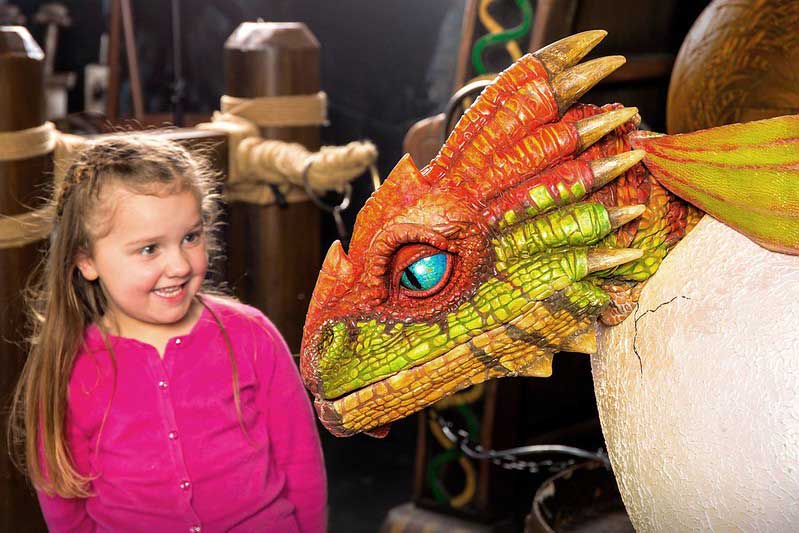 child with dragon at shrek's adventure