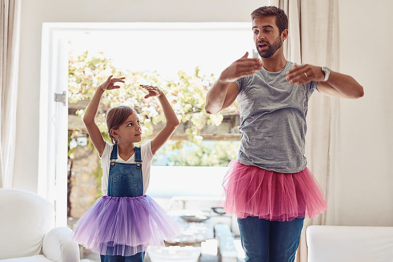 Father coaching daughter in ballet for kids at home