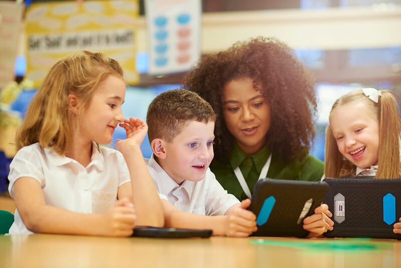 Children looking at noun phrases for ks2 pictures on their tablet