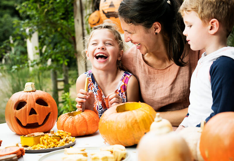 Family laughing at Halloween holiday jokes